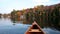 Autumn lake reflection with a canoe