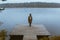 autumn lake season woman in coat at wooden pier