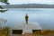 autumn lake season woman in coat at wooden pier