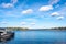 Autumn landscape of the coast of Sweden. Forest islands with colorful trees in the gulf of the Baltic Sea. The yacht boat moored