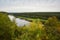 Autumn landscape on cool, cloudy day. Panoramic view of forest and Neman river