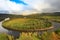 Autumn landscape with curving river and forest