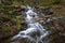 autumn landscape of flowing cascade water in a mountain river