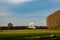 Autumn landscape with flying egret. Blue sky over an empty field