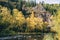 Autumn landscape. Forest, river, stones, rock, leaves.