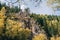 Autumn landscape. Forest, river, stones, rock, leaves.