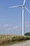 Autumn landscape with giant wind power turbines in a crop field