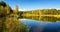 Autumn landscape on the lake with birch forest on the shore, Russia, Ural,