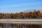 Autumn landscape with Moscow river and Luzhniki stadium in october sunny mornig with blue sky and airplane contrail