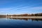 Autumn landscape with Moscow river and Luzhniki stadium in october sunny mornig with blue sky and airplane contrail