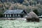 Autumn landscape in North of Russia with village house and haystack