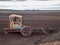 Autumn landscape with an old iron tractor in a peat bog