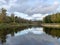 Autumn landscape with river, calm water, beautiful colorful trees, water reflections, river Gauja, Valmiera, Latvia