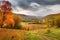 autumn landscape with rolling hills, colorful foliage, and peaceful solitude
