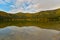 Autumn landscape. Saint Ana lake in Romania, the only volcanic lake in Europe, formed in a crater of a dead volcano