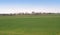 Autumn landscape with seeded field and village