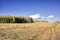 Autumn landscape sloping meadow on a background of forest and mountains