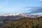 Autumn landscape with snow covered mountains, colorful leaves and sky with special clouds