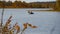 Autumn landscape. Two fishermen on a rubber boat fishing on the lake. Sunny autumn day