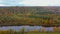 Autumn Landscape View of the Gauja River Surrounded by Forests Colorful Bright Yellow Orange and Green Trees, Sunny Day.