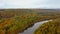 Autumn Landscape View of the Gauja River Surrounded by Forests Colorful Bright Yellow Orange and Green Trees, Sunny Day.