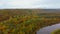 Autumn Landscape View of the Gauja River Surrounded by Forests Colorful Bright Yellow Orange and Green Trees, Sunny Day.