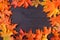 Autumn leaf on wood black background orange leaf on old grunge wood deck, copy place for inscription, top view, tablet for text