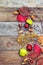 Autumn leaves with acorn, twig, chestnut over wooden background