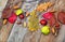 Autumn leaves with acorn, twig, chestnut over wooden background