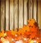 Autumn leaves on the background of a wooden wall