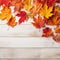 Autumn Leaves Decoration on White Wooden Table with Copy Space, Textured Vintage Background