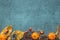 Autumn Leaves, decorative pumkins, acorns and cones over blue wooden background