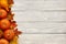 Autumn leaves and pumpkins over old wooden background