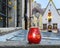 Autumn leaves  red  candle cup and city clock   on medieval wall at roof in Old town of Tallinn people walk at evening travel to