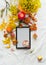Autumn lifestyle flat lay with empty letter board , hot chocolate, burning candle, pumpkins and yellow fall leaves branches. Top