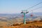 Autumn Majesty: Vintage Cable Car Embraced by Sunlit Mountain Splendor