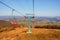 Autumn Majesty: Vintage Cable Car Embraced by Sunlit Mountain Splendor