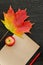Autumn maple leaf, apple, paper for text and pencil