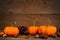 Autumn mini pumpkins over rustic old wood background