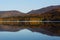 Autumn mirror reflection in lake Pasanauri, Georgia