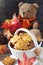 Autumn mood: cinnamon cookies in form of maple leaves, red leaves and Teddy bear