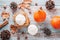 Autumn mood cozy flat lay with pumpkin latte, cedar pine cones, pumpkins and dried leaves on worn wood background, top view, fall