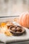 .autumn mood: pumpkin and cookies on the windowsill in October