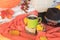 Autumn mood-warm red sweater, hat and a  cup of hot coffee in the framing of autumn leaves which  turn into the warm colors of