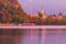 Autumn morning in the Bled Lake. St. Martin`s Parish Church reflected in water. First rays of the sun illuminate the landscape