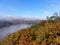 Autumn morning in a forest on the lookout above a river