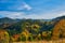 Autumn Morning in the Mountains: A Serene Village in the Valley Surrounded by Majestic Peaks