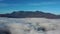 Autumn morning over mountain lake, drone flying over cloud and mountain landscape