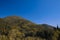 Autumn mountain landscape October month brown foliage clear weather day scenic view with blue sky background empty