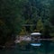 Autumn mountain landscape with shady lake, picnic gazebo and hanging bridge